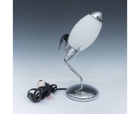 Accent lamp, modeled in the form of a rocket, with a pointed, smooth, and oval-shaped light cover. Completed by a has a round