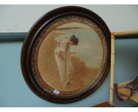 Circular seashore print of a young maiden inspecting a seashell (20" diam) in contemporary frame