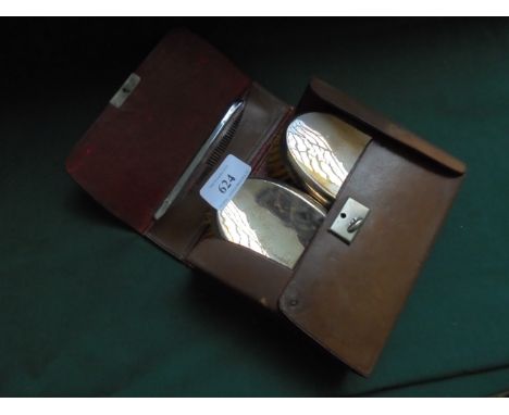 Pigskin case of 2 silver backed hairbrushes (Birmingham 1918) with comb (not matching)