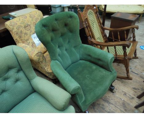 Most genuine early Victorian button backed fireside armchair on splayed cabriole feet on brass castors, the buttoned arms and