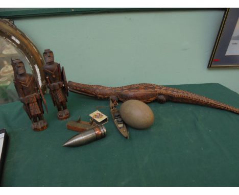 Magpie lot of a Portuguese carving of an African snake, pair of carved wooden Warrior ornaments, Ostrich egg, WW II bullet he