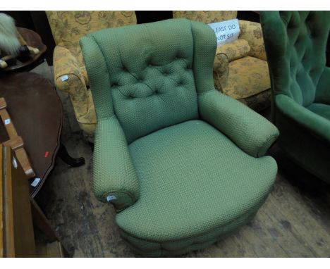 Easy button backed fireside chair, the padded backs, arms and seat upholstered in olive green and gilt contemporary patterned