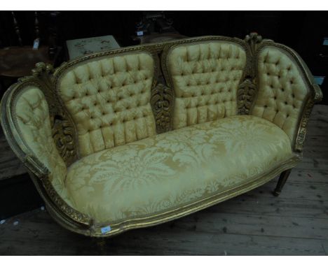 Ornate Flemish style couch, the gold painted frame inset 4 padded button backed panels to back, the shaped deeply padded seat