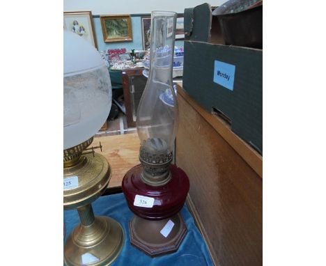 Oil lamp with ruby glass bowl on hexagonal wooden and copper plinth