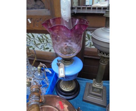 Ornate oil lamp with blue glass bowl, delicate part cranberry glass shade on gilt ebonised circular pinth