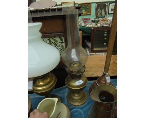 Brass oil lamp with shaped bulbous flue together with Famous Grouse Fine Scotch Whisky water jug 