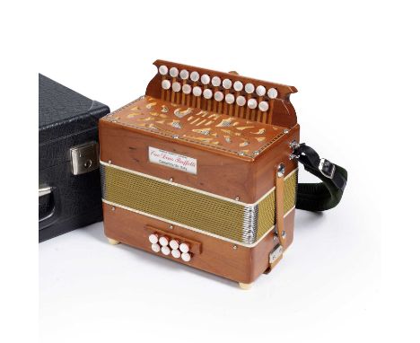 A Cav. Dino Baffetti melodeon with fretted end board and twenty one push button notes, Accordions of London Retailers, cased