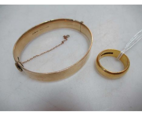 A hallmarked 22ct gold wedding band, 14.3g, together with a bangle stamped '9CT SOLID METAL CORE' 28.2g (2)