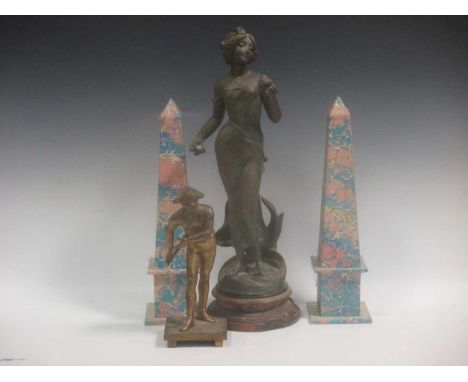 A gilt metal figure of Harlequin, a patinated spelter model after Ranieri and a pair of marbled paper obelisks (4)