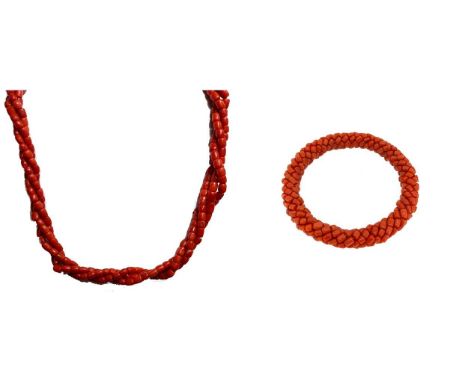 An early 20th century three strand coral necklace with bangle en suite, 102.9g gross (2)