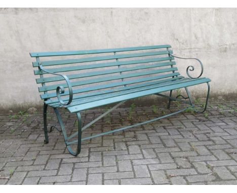 A green painted garden bench with metal scroll end supports and wooden slats. 176 cm Wide