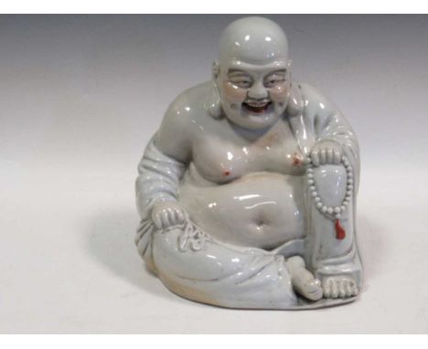 A model Buddha, mid 20th century, white glazed, some painted decoration 33cm high