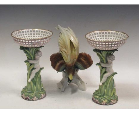 A pair of Berlin porcelain figural tazze together with a Karl Enns model of a bird of paradise