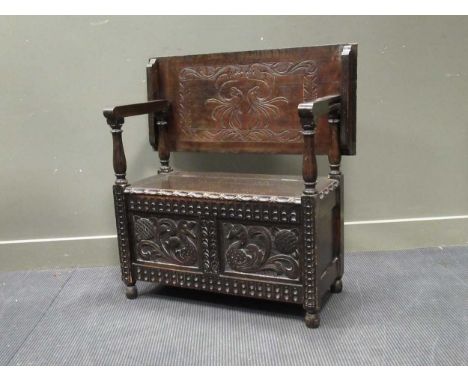 A carved oak monk's bench, 80 x 92 x 42cm