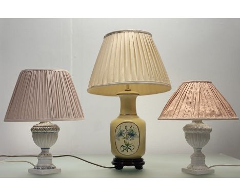 A trio of table lamps comprising, an Italian porcelain blue,yellow and white urn style table lamp with a baby pink lamp shade