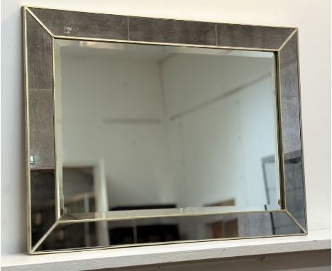 A large modern mantel mirror, with smoked glass finish panel border with gilt metal edges, with bevelled glass panel. (82cmx1