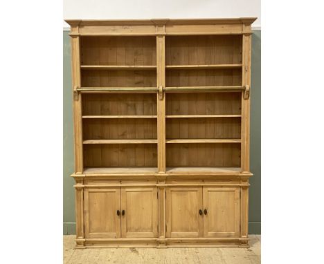 A modern pine two part bookcase in the Victorian country house style forming two sections fitted with four adjustable shelves