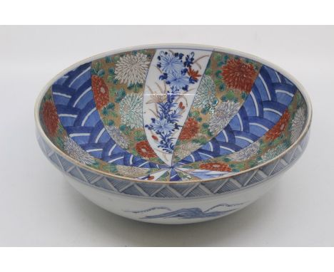 A Japanese Imari bowl, probably late Edo period, of rounded form with moulded rim, decorated with panels of overlapping scale