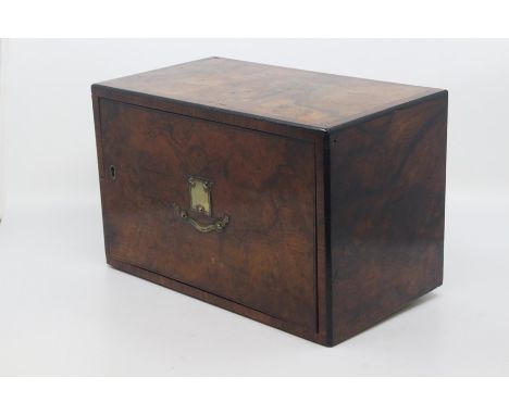 An Edwardian walnut cross-banded revolving cigar case, circa 1910, of rectangular outline with cross-banded and ebonised edge
