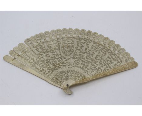 A Chinese Canton ivory brise type fan, early 19th Century, the guards carved with dense flowers and foliage, the sticks with 