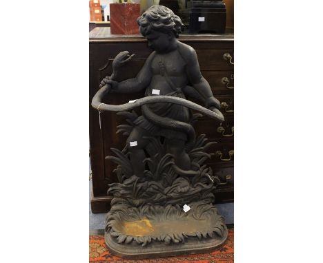 A figure of a boy wrestling a snake designed into a stick stand with drip tray, late 19th Century, made from cast iron, good 