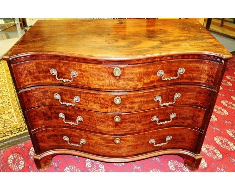 A George III mahogany serpentine fronted chest of drawers, circa 1765, comprising four long graduated drawers with cock-beade