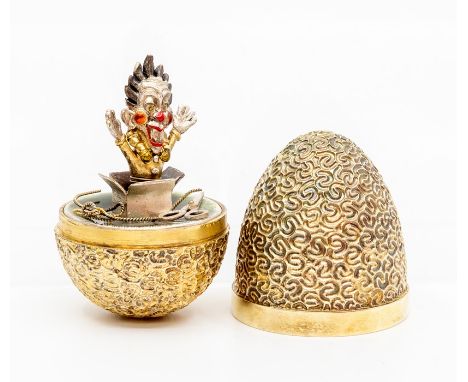 Stuart Devlin- a silver gilt surprise 'clown' egg, silver textured form opening to reveal a wobbling clown with enamel detail