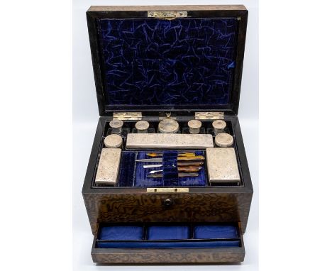 A Victorian Ladies silver-mounted travelling dressing table set, the silver by William Neale, London, 1855 - the covers with 