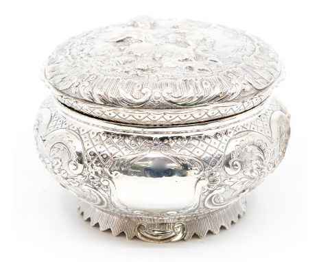 A late Victorian silver circular embossed box and cover, the cover chased with central section depicting a Satyress holding a