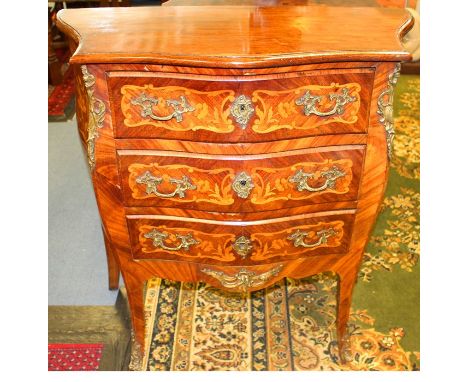 A 19th Century Continental kingwood and marquetry inlaid commode, possibly Dutch, of Bombe form, fitted with three drawers in
