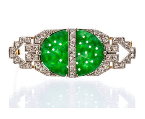 An Art Deco jade and diamond brooch, the rectangular brooch set to the centre with an oval jade with carved and pierced cherr