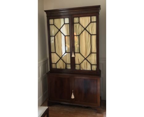 Mahogany cupboard, upper section with astrigal glazing above a 2 door cupboard opening to reveal shelf 206 h X 108 w cm 