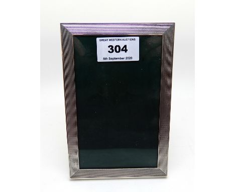 A rectangular silver mounted photo frame by Sanders &amp; Mackenzie, Birmingham 1973, with engine turned decoration, 15cm x 1