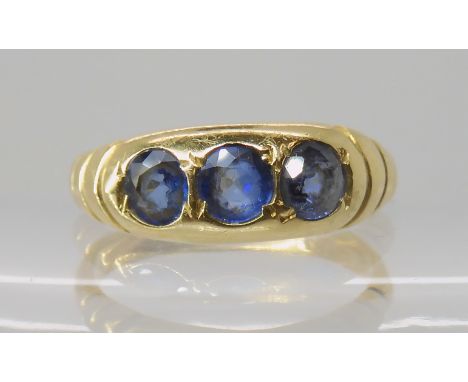 An 18ct gold three sapphire ring, size R, weight 4.2gms Condition Report: Available upon request