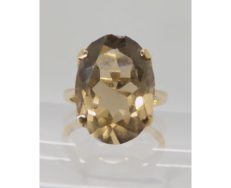 A bright yellow metal ring set with smoky quartz, size Q, weight 5.1gms Condition Report: Available upon request