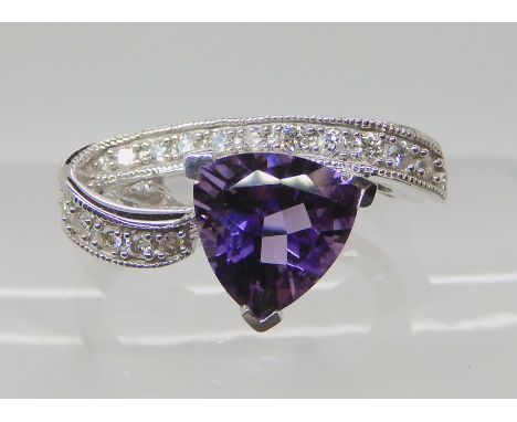 An 9ct white gold trilliant cut amethyst and diamond dress ring, diamonds estimated approx 0.09cts finger size N1/2, weight 3