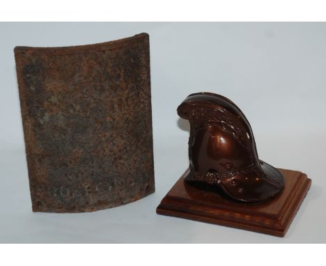 A cast iron warning notice, 19 x 14cm and a paperweight formed as a fire helmet Condition Report: Available upon request