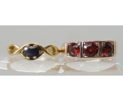 A 9ct gold three garnet ring size R, together with a yellow metal sapphire ring size Q, weight combined 7.7gms Condition Repo