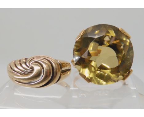 A yellow metal smoky quartz set ring size O1/2, and a 9ct gold wave design ring size R1/2, weight together 11.4gms Condition 