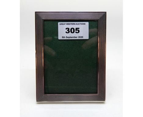 A rectangular silver mounted photo frame by Sanders and Mackenzie, Birmingham 1976, with engine turned decoration, 11.4cm x 9