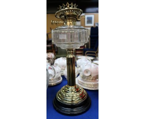 A brass oil lamp with glass font Condition Report: Available upon request