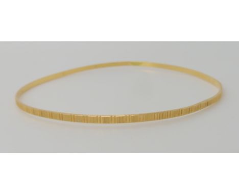 An 18ct gold diamond cut engraved bangle, inner diameter 6.5cm, weight 4.3gms Condition Report: Available upon request