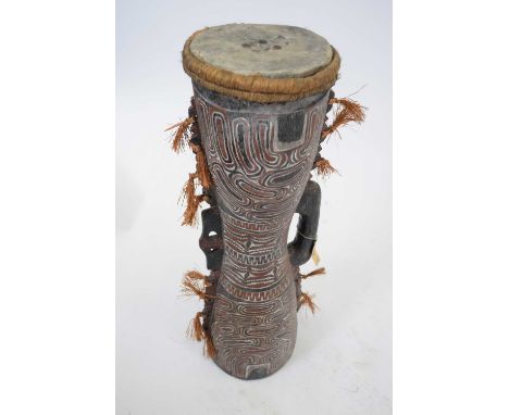 Tribal/ethnographica interest - Papua New Guinea carved wooden drum with stretched hide and single handle surrounded by fibre