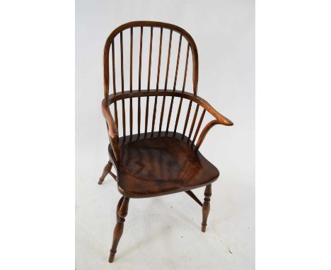 Good quality elm seated Windsor chair with stick back over a saddle seat raised on turned legs with crinoline stretcher, 100c