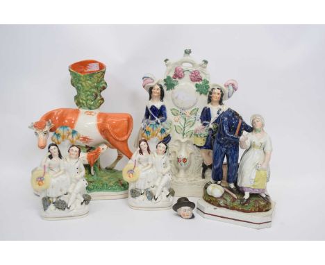Group of Stafforeshire wares including a model of a cow and heifer, and group of gentleman and lady (qty)