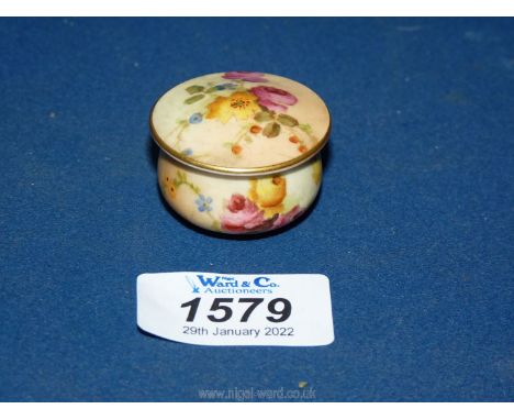 A Royal Worcester blush pill box decorated with roses, lid diameter 1 3/4" x 1" tall.