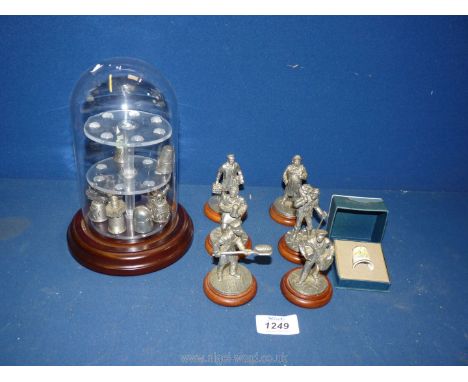 Six English miniatures made of metal including the coal man, butcher, milkman, baker etc, a thimble display having a glass do