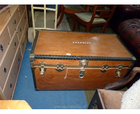 A large wooden travel trunk "S. Herbert" with metal fittings and an interior shelf, front bowed, 39 1/2" x 20" x 21 1/2".