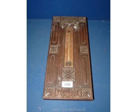 A wooden thermometer in carved frame, 15 3/4" x 6 3/4".