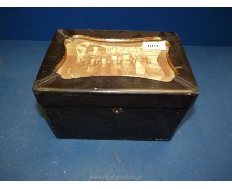 A small ebonised Tea Caddy decorated with a black and white  scene of an oriental family, hinge to lid broken.